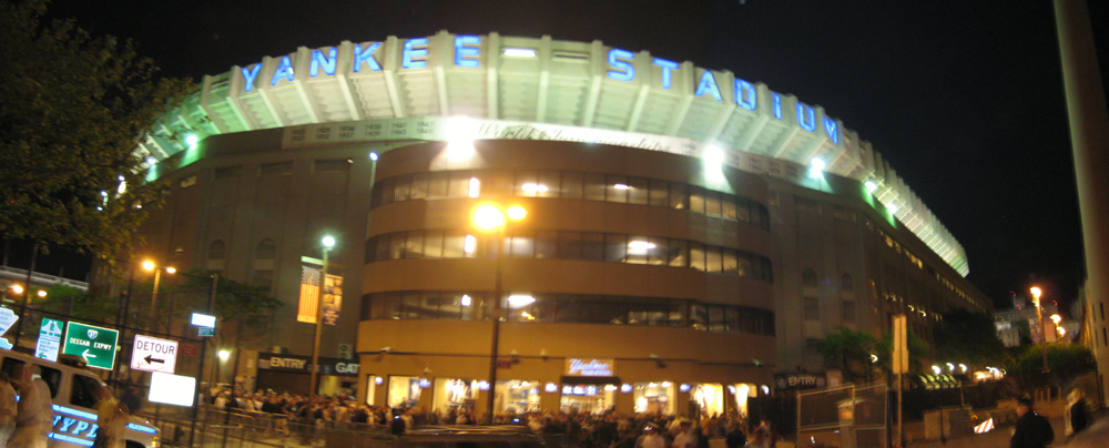 View from street level behind home plate at night